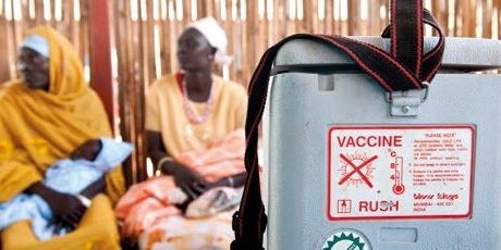 Vaccine Container with woman in background