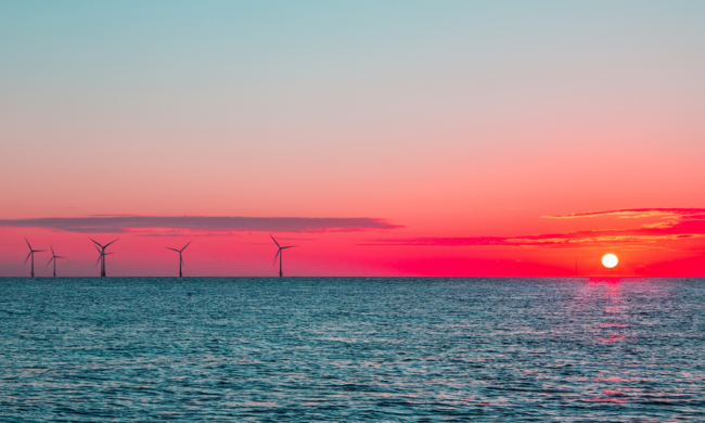 Ocean with Wind Turbines and Sun Setting